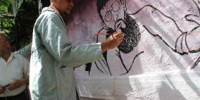 رسم حي لجدارية تضامنية لخضر عدنان في اعتصام ذوي أسرى غزة