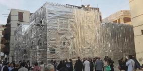 فنان يغطي أحد مباني جدة القديمة بورق القصدير